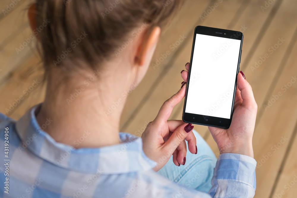 Mockup image: woman looking at black smartphone with white blank screen. Close up view of woman hands with smart phone mobile device. Mock up, copyspace, template and technology concept