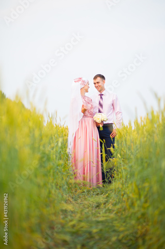 Bride and groom in field. Muslim marriage. photo