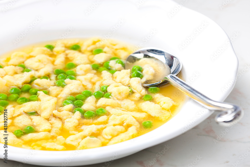 chicken bouillon with homemade dumplings and green peas chicken bouillon with homemade dumplings and green peas