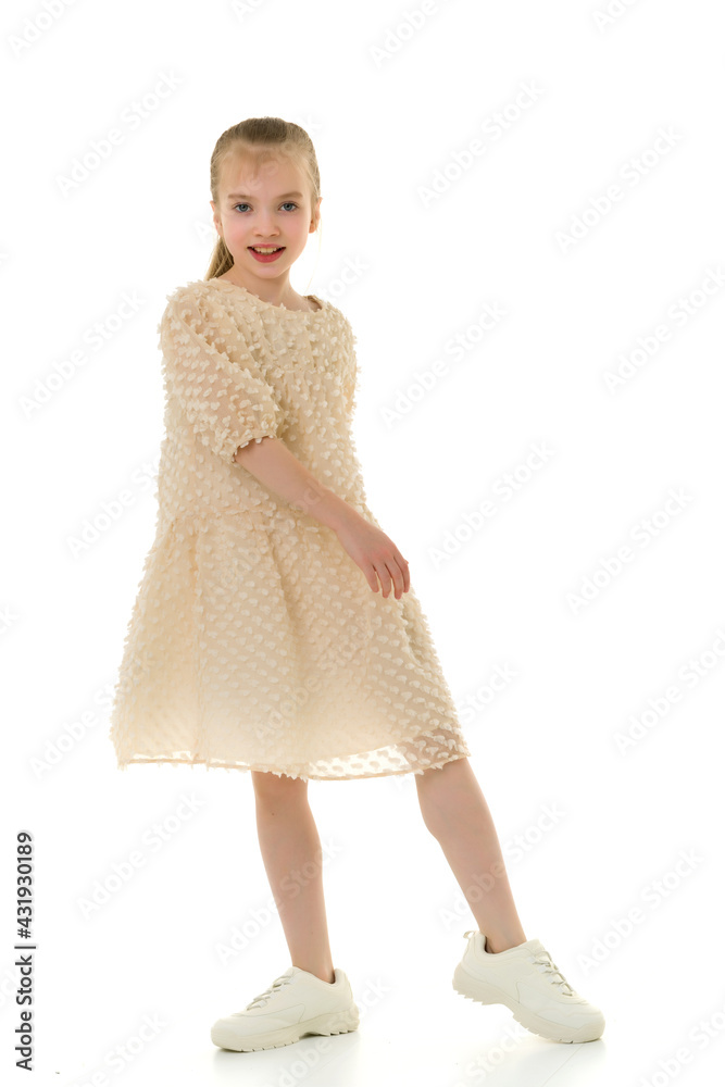 A cheerful little girl is dancing.The concept of a school of dance. A cheerful little girl is dancing.The concept of a school of dance.