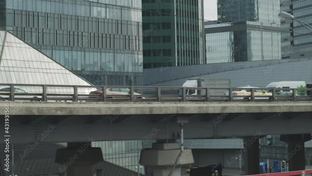Urban industrial view from train window. Bridge constructions with road with cars Urban industrial view from train window. Bridge constructions with road with cars