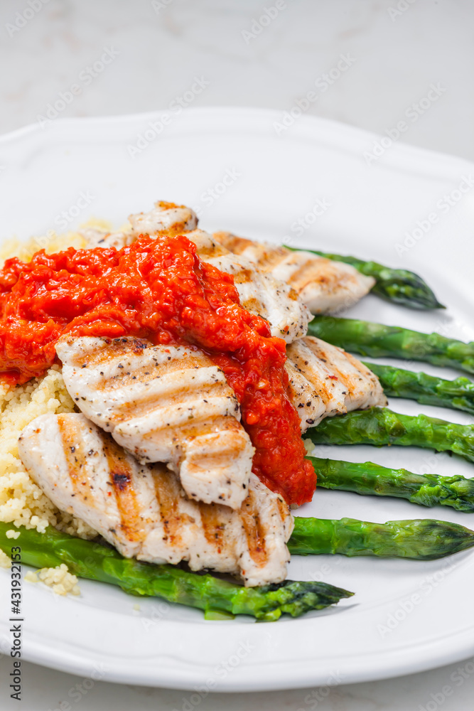 grilled poultry meat with baked red pepper sauce and green asparagus grilled poultry meat with baked red pepper sauce and green asparagus