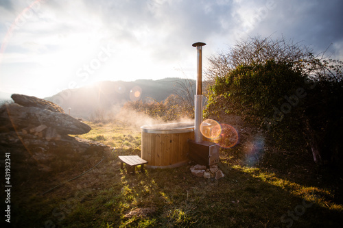 Obraz na płótnie Amazing romantic location for steaming hot tub warmed by fire wood