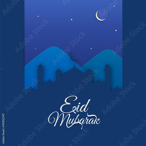 Eid Mubarak Font With Paper Cut Mosque And Mountain On Blue Night Time Background.