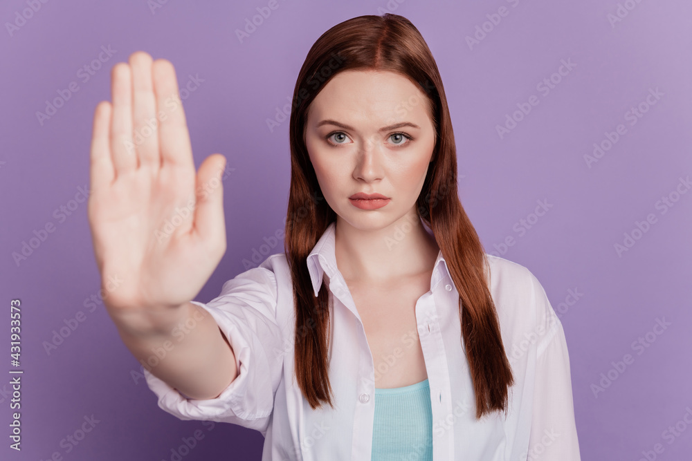 Portrait of confident angry lady hands show stop sign on violet background Portrait of confident angry lady hands show stop sign on violet background