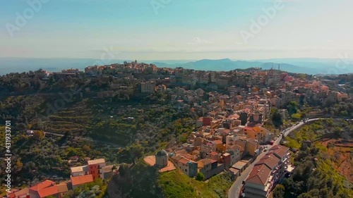 POI, drone aerial footage of the town of Centuripe in eastern Sicily, with an overview of the Etna active volcano, during early spring in Italy.