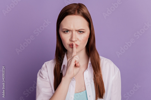 Portrait of annoyed lady forefinger cover lips ask silence on violet background