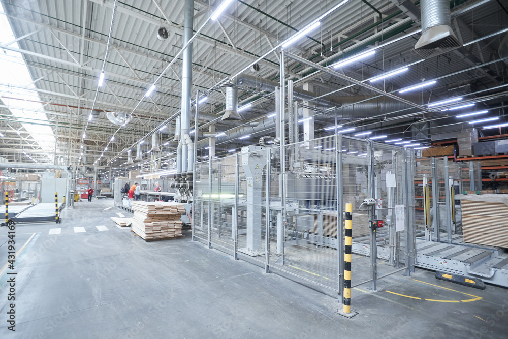 Obraz premium Carpentry factory. Automated equipment for laminate production. Modern robotic factory indoors. Woodworking production