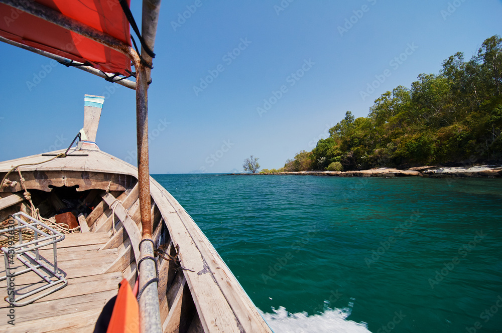 Travel by Thailand. Bow of traditional thai wooden longtail boat sailing the sea.
