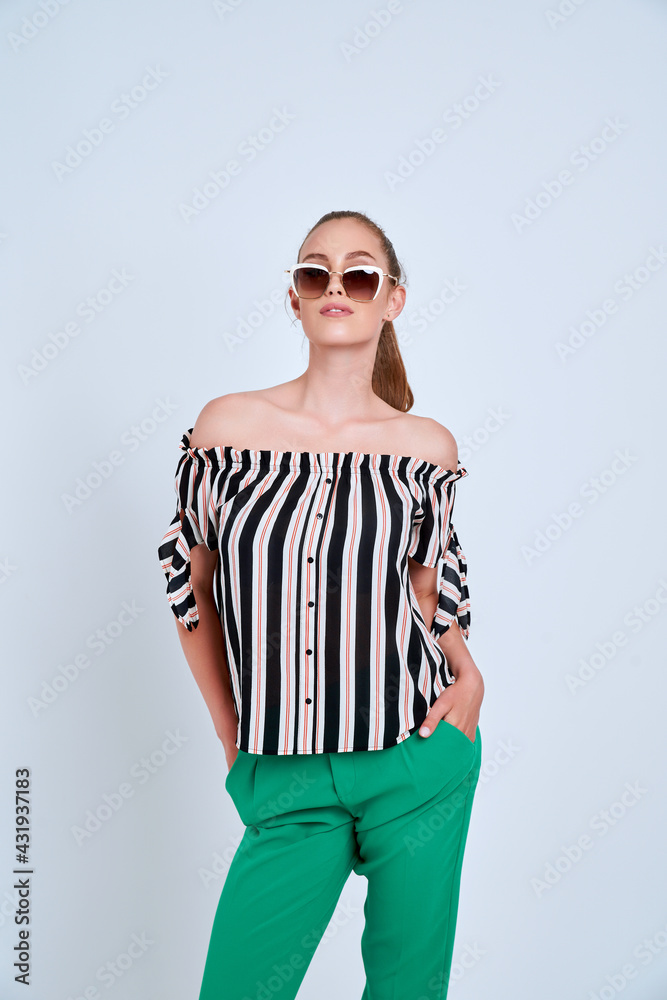beautiful young girl in striped shirt and green trousers isolated on white background beautiful young girl in striped shirt and green trousers isolated on white background