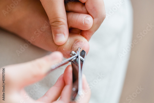 clean nails.kid child girl cutting nails using stainless steel nail clipper at home.Hygiene.virus bacteria in nails.Toe nail cutting with a cutter.sanitizer hand.coronavirus covid19.skin care.
