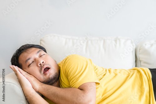 Fotografía Asian man take a nap on sofa with snore