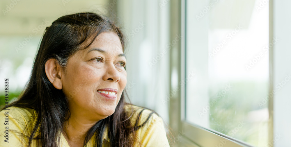 Portrait of senior woman.Senior Adult Women Smiling Happy.Hope with indian mother woman at home.60 years old women.Grandmother grandparent.Kind face looking window.mother day.retirement, alzheimer. Portrait of senior woman.Senior Adult Women Smiling Happy.Hope with indian mother woman at home.60 years old women.Grandmother grandparent.Kind face looking window.mother day.retirement, alzheimer.