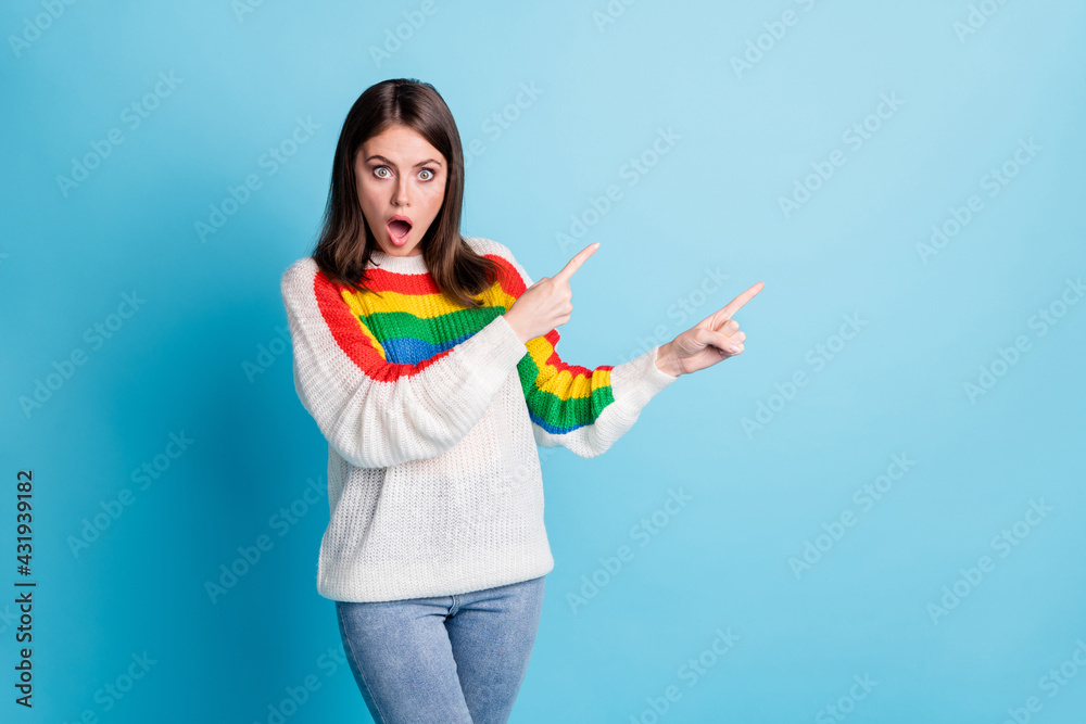 Portrait of shocked pretty person open mouth direct two hands fingers empty space isolated on blue color background Portrait of shocked pretty person open mouth direct two hands fingers empty space isolated on blue color background