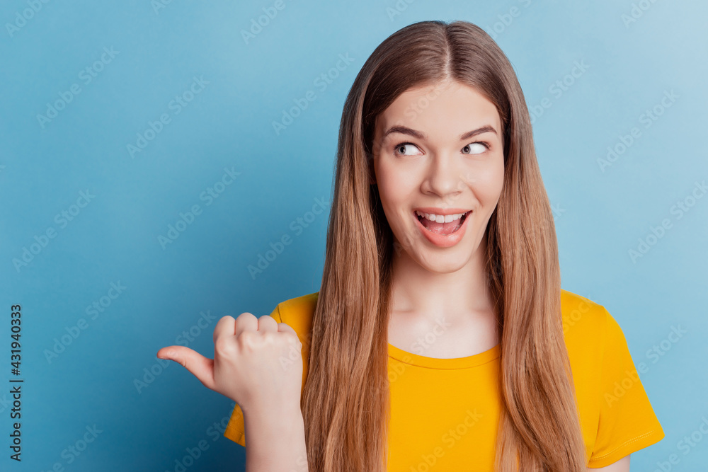 Portrait of adviser girl direct thumb away empty space on blue background Portrait of adviser girl direct thumb away empty space on blue background