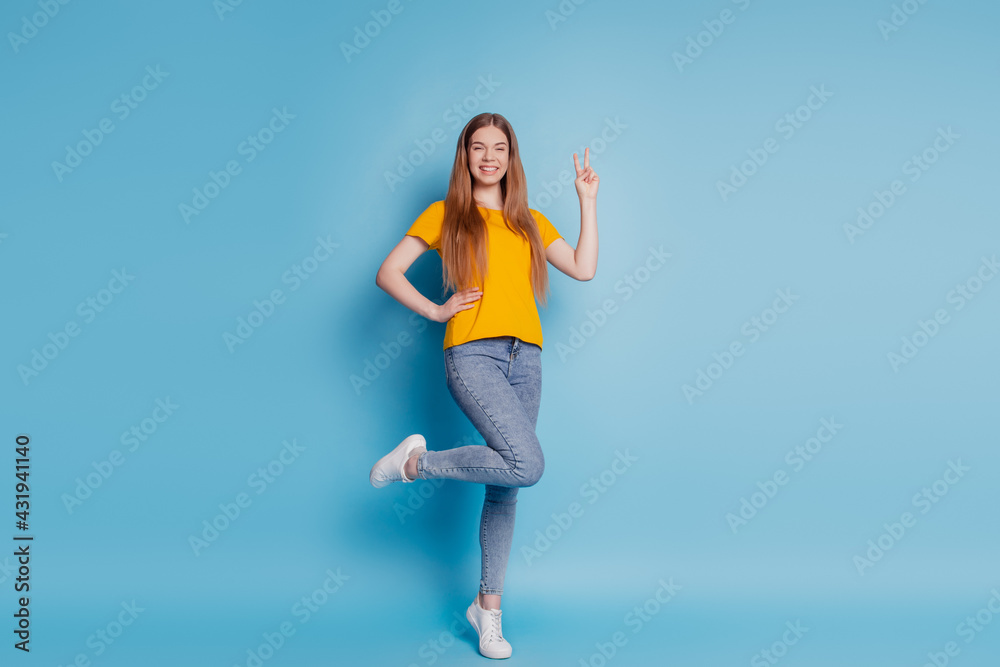 Portrait of cheerful dream lady show v-sign wear casual clothes on blue background Portrait of cheerful dream lady show v-sign wear casual clothes on blue background