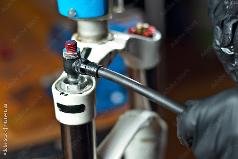 The master inflated the bicycle frame. Pump and male hands close up. The master inflated the bicycle frame. Pump and male hands close up.