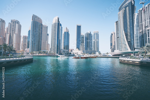 Sunny day cityscape of Dubai marina embankment with skyscraper. © luengo_ua