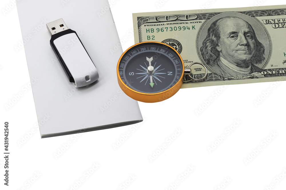 Classic navigation compass on American dollars flash drive on white paper isolated on white background as symbol of tourism with compass, travel with compass and outdoor activities with compass Classic navigation compass on American dollars flash drive on white paper isolated on white background as symbol of tourism with compass, travel with compass and outdoor activities with compass