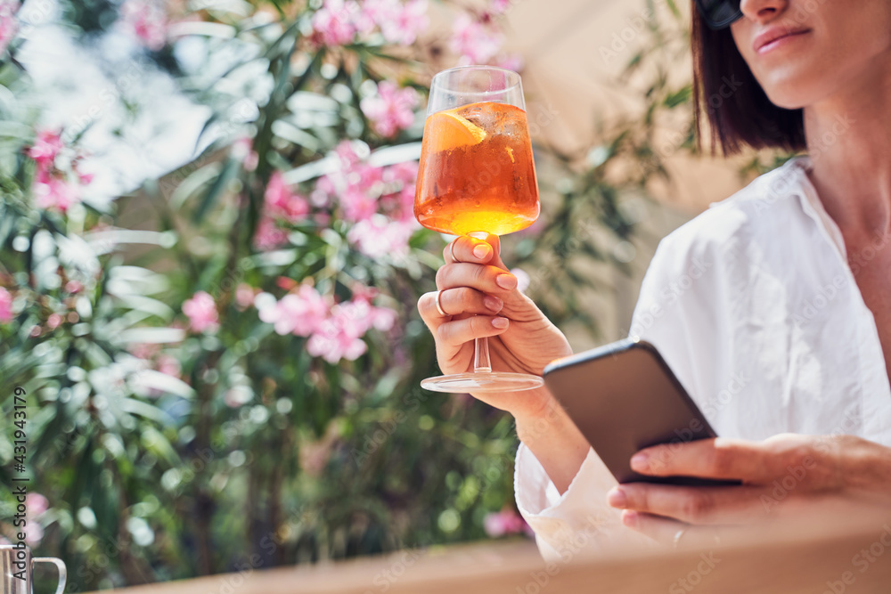 Cropped shot of attractive girl drinking aperol - obrazy, fototapety, plakaty 