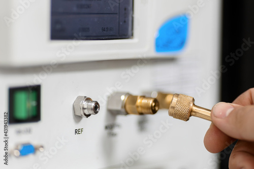 Canvas Print The metrology and standardization laboratory specialist connects the device under test pressure gauge to the pressure calibration and verification instrument