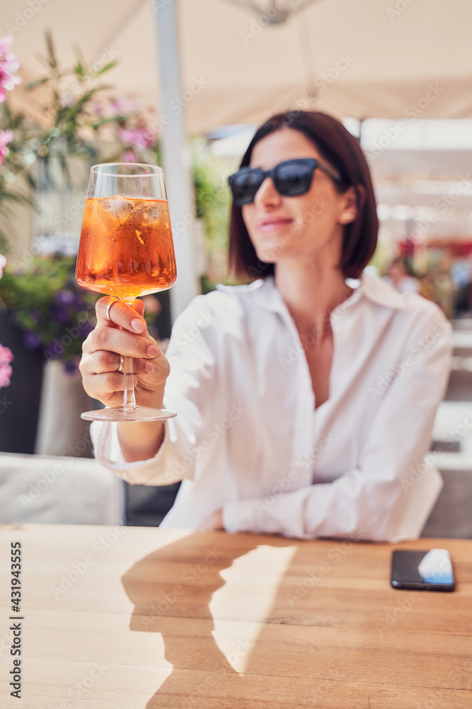 Attractive girl drinking aperol in restaurant terrace - obrazy, fototapety, plakaty 