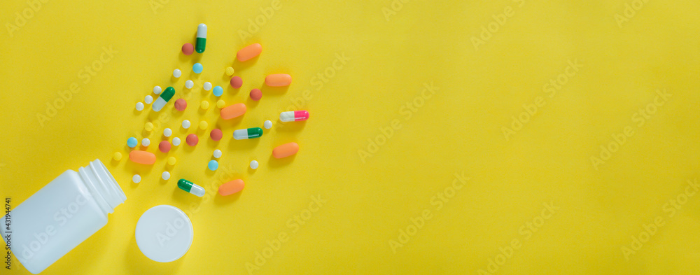 Pills and medicine bottles on a yellow background,All kinds of drugs to be put into the medicine bottle on the yellow background