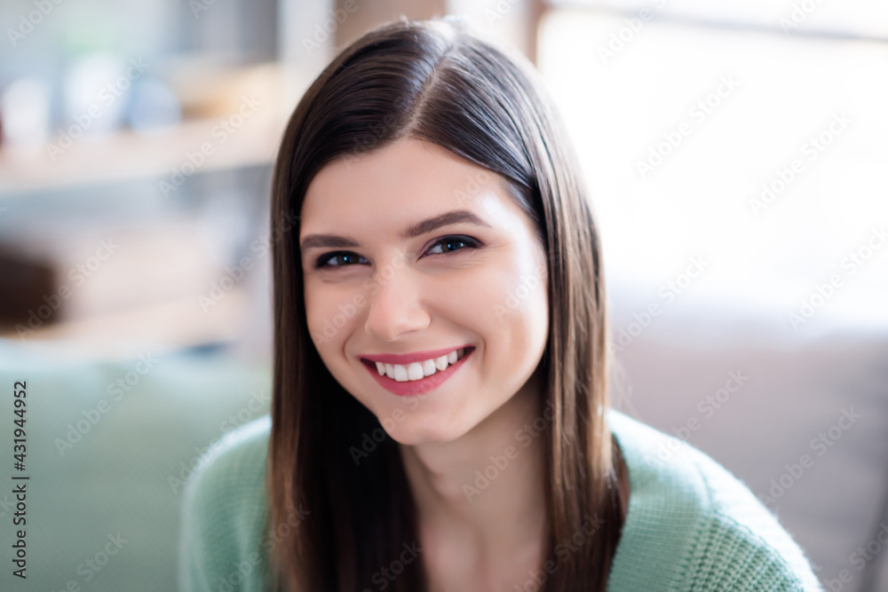 Portrait of young beautiful smiling woman sitting on divan at home Portrait of young beautiful smiling woman sitting on divan at home