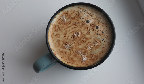 Cappuccino in a gray and blue mug on a white background
