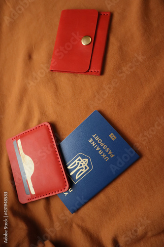 Leather wallets and passport on a brown background