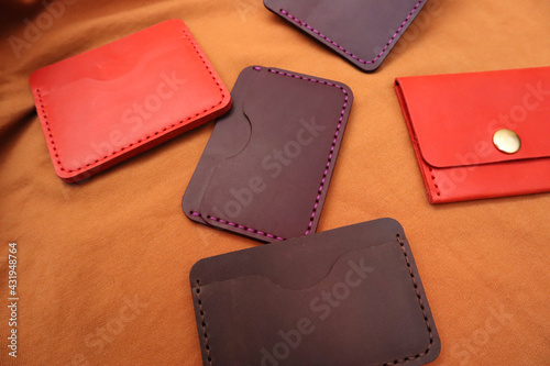 Handmade leather cardholders on a brown background