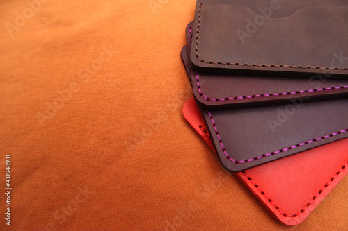 Handmade leather cardholders on a brown background