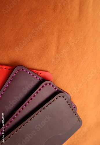 Handmade leather cardholders on a brown background