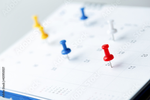 Thumbtack in calendar concept for busy, appointment and meeting reminder, planning for business meeting or travel planning concept.