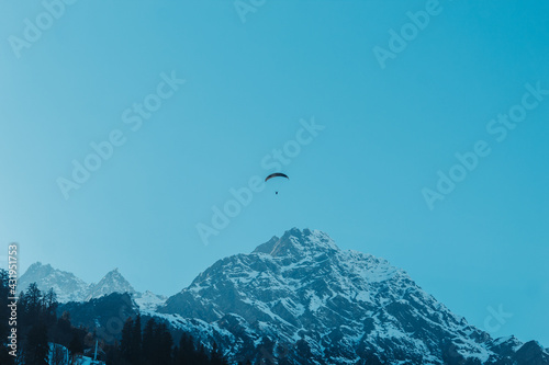 View of the parachute above the snow covered mountain peak at Solang Valley in Manali, Himachal Pradesh, India