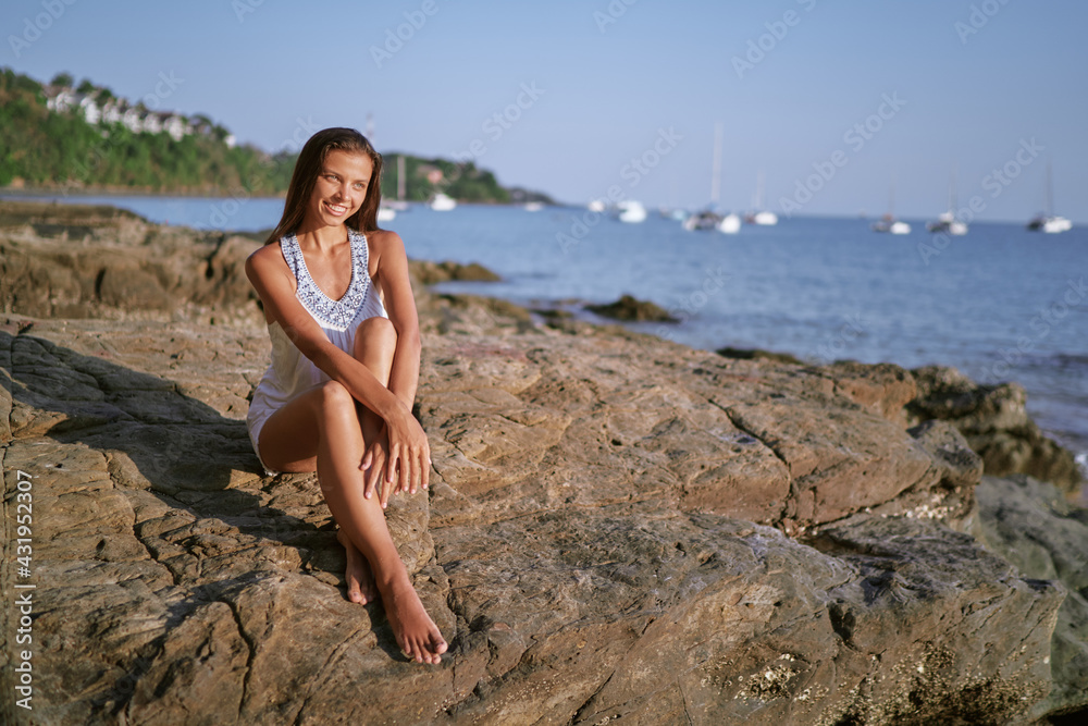 Outdoor portrait of young beautiful woman with long hair on the sea beach. Outdoor portrait of young beautiful woman with long hair on the sea beach.
