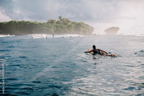 Woman on surfboard on the sea, Siargao Island, Philippines photo