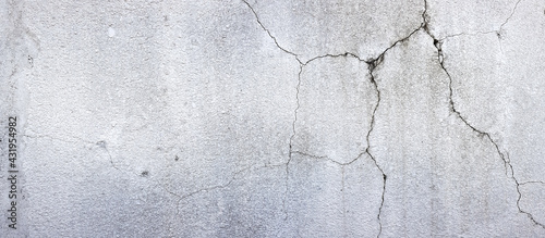 texture of old plastered white wall with cracks