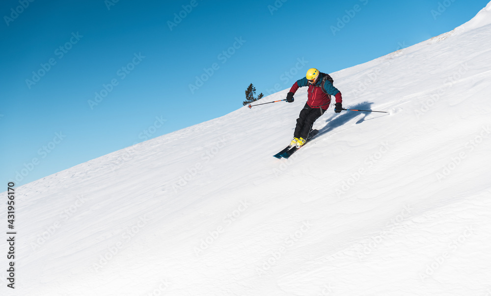 Mature man skiing on mountain slope against sky Mature man skiing on mountain slope against sky