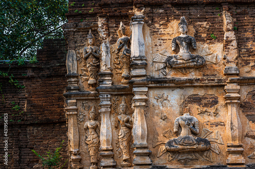 Old Ancient stucco patterns stucco Buddha and angel figures on the outside of the Maha Chedi Wat Chet Yot, seven pagoda temple It is a major tourist attraction in Chiang Mai, Thailand.