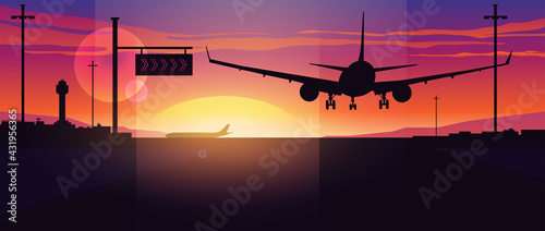 Airplane landing at sunset. Panoramic view of the evening airport