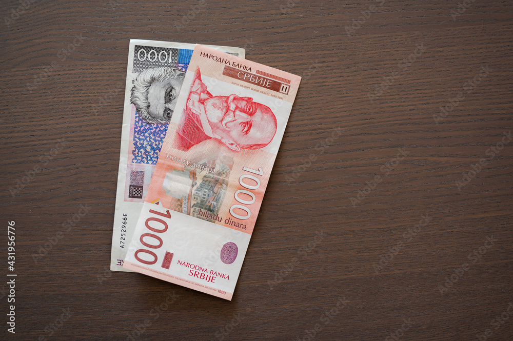 Obraz premium Serbian and Croatian paper money, 1000 kunas i 1000 dinars bills, flat lay.