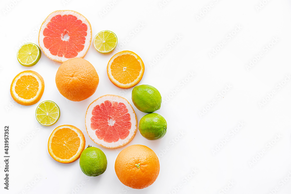 Citrus fruits on a white background are cut . Colored fruits. The citrus family. citrus sliced layout top view on a white background. An article about healthy eating. Keto diet. Citrus fruits on a white background are cut . Colored fruits. The citrus family. citrus sliced layout top view on a white background. An article about healthy eating. Keto diet.