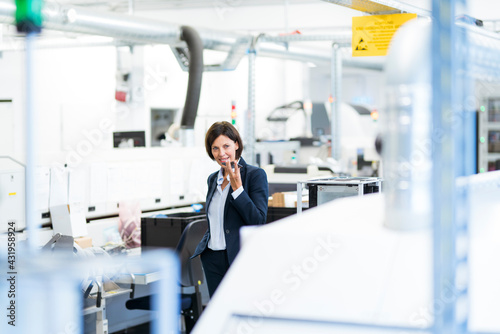 Female professional sending voicemail through smart phone at office