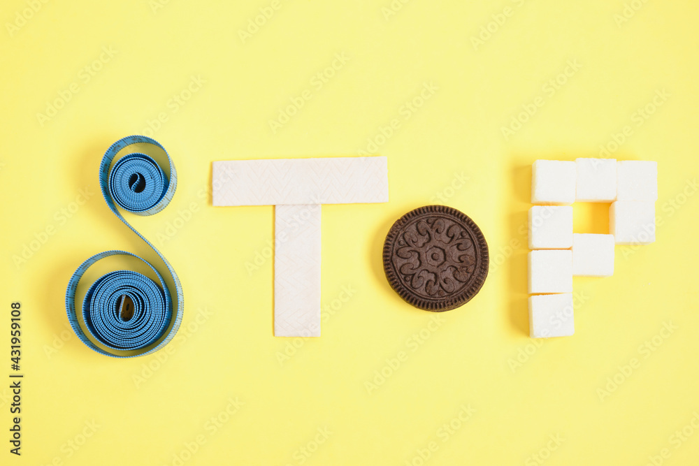 inscription stop from a measuring tape, chewing gum. cookies and sugar inscription stop from a measuring tape, chewing gum. cookies and sugar