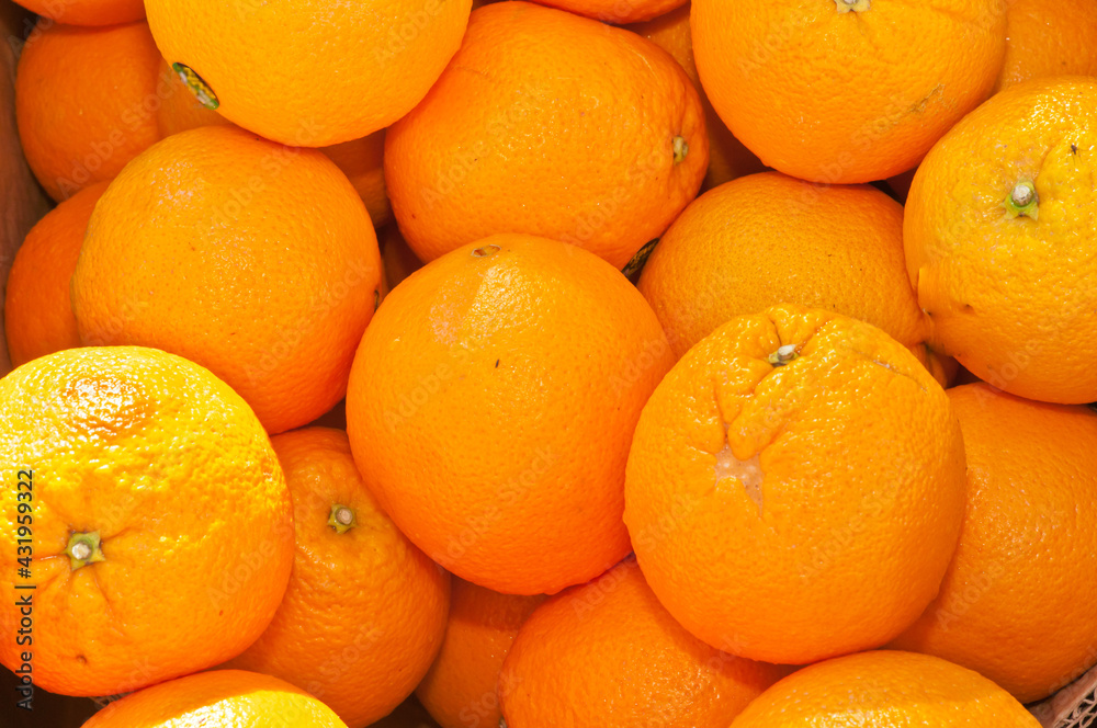 front view, close distance of a pile of local, ripe, freshly picked oranges on display and for sale at a tropical farmers market front view, close distance of a pile of local, ripe, freshly picked oranges on display and for sale at a tropical farmers market