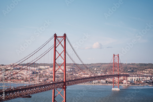 Beautiful landscape with suspension 25 April bridge bridge over the Tagus river in Lisbon, Portugal.