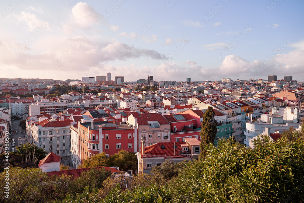 Beutiful view of old town in Lisbon. Red tiled roofs and blue sky.