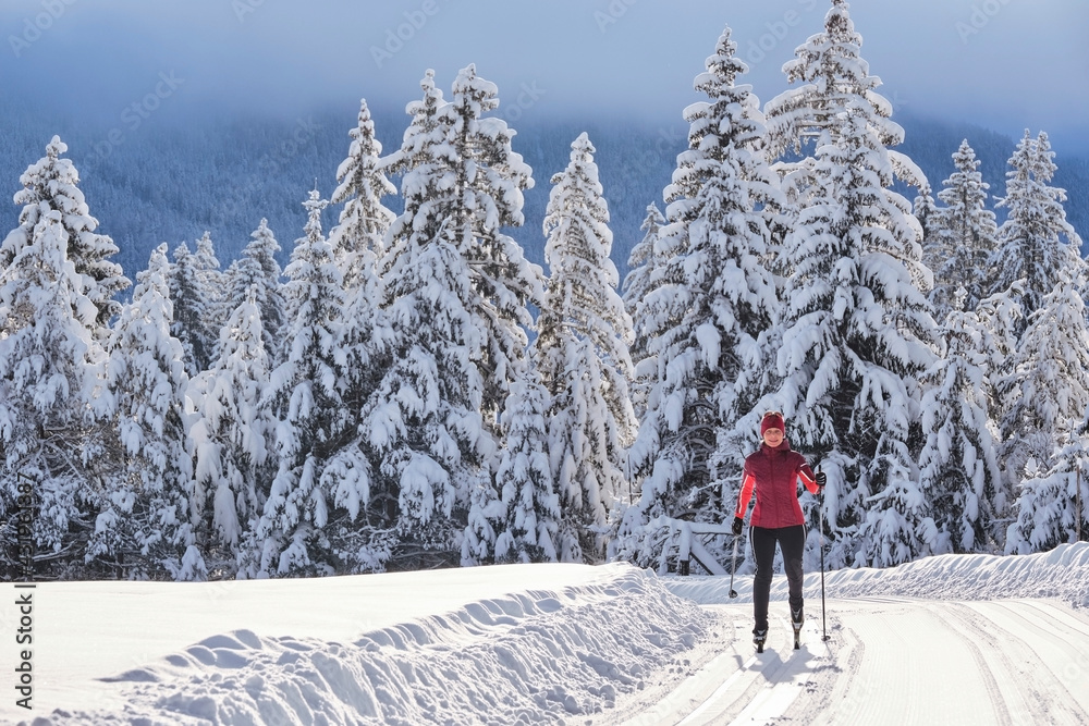 Senior explorer skiing on ski -slope over mountain in forest Senior explorer skiing on ski -slope over mountain in forest