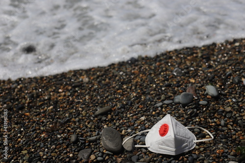 Medical protective antiviral mask with valve on the seashore.